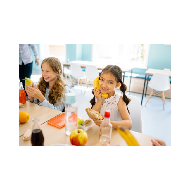 Picture of 2 children sitting at a table eating fruit