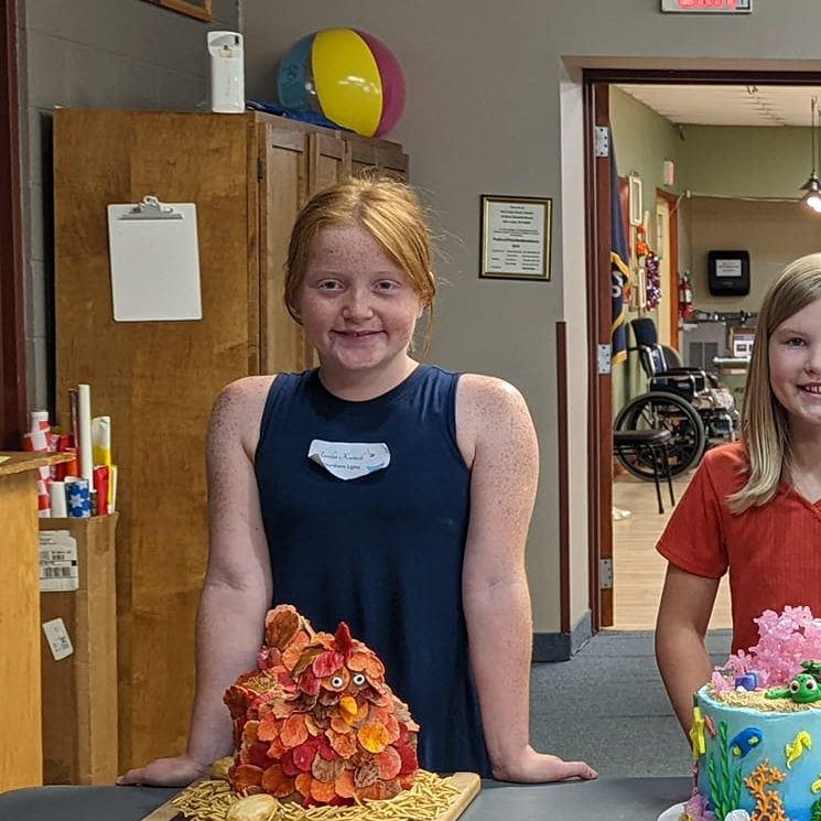 youth showing cakes